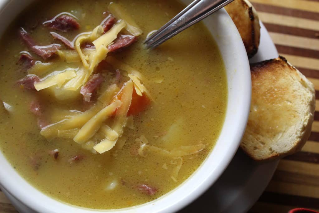 bowl of savory ham hock soup with buttery toast
