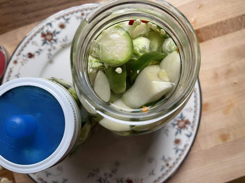 mason jar with brussels sprouts and garlic in it