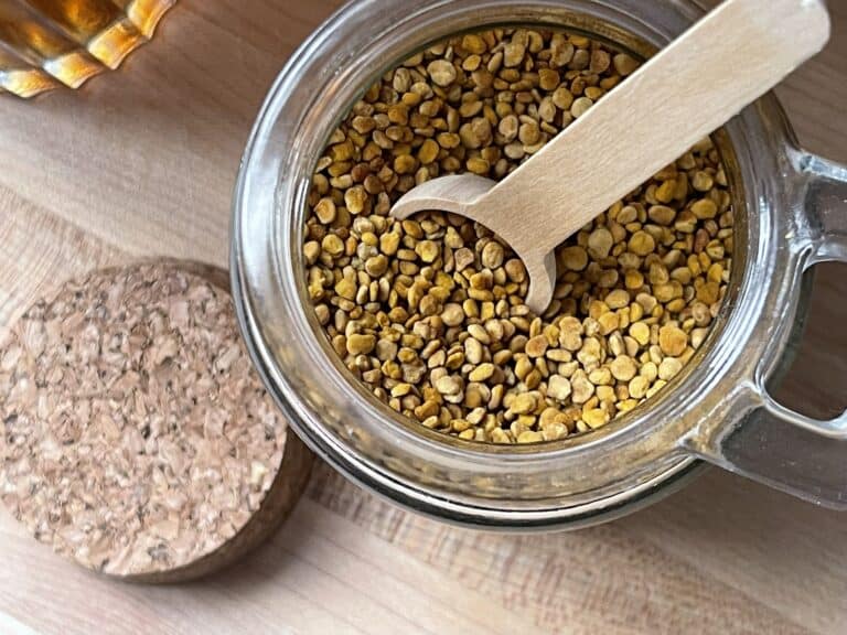 bee pollen in a glass jar with a small wooden spoon inside rough and tumble farmhouse